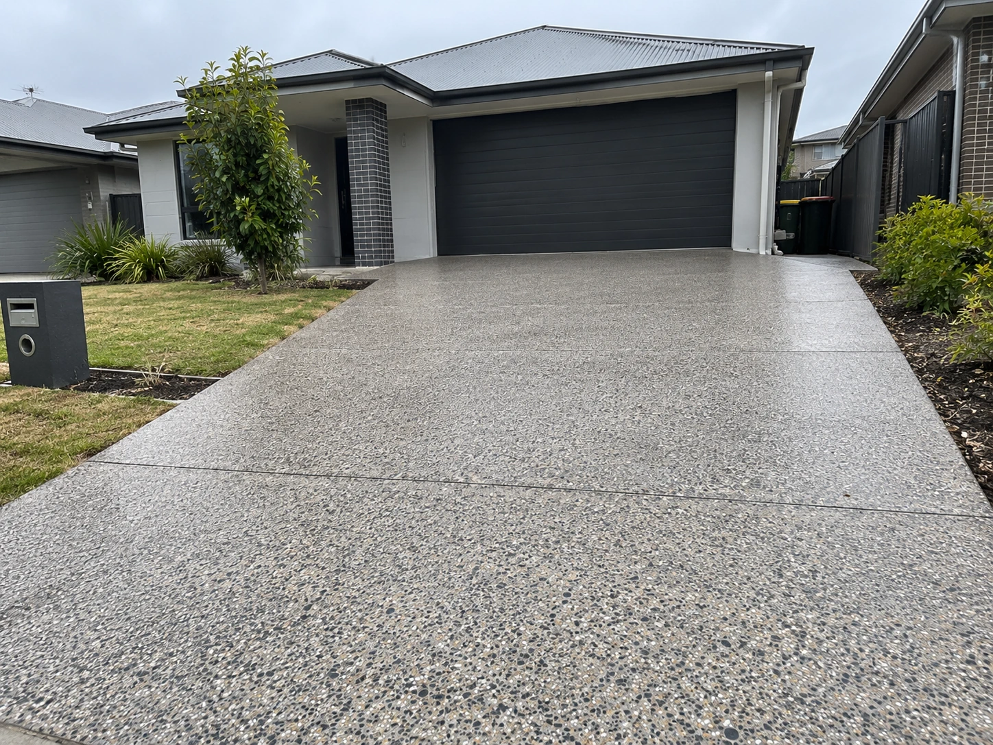 A decorative concrete driveway that has been resurfaced on a property in Wollongong