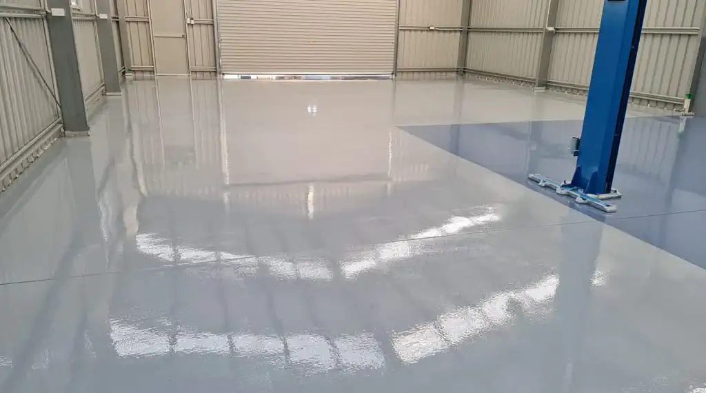a garage floor with epoxy coating applied to it in Wollongong